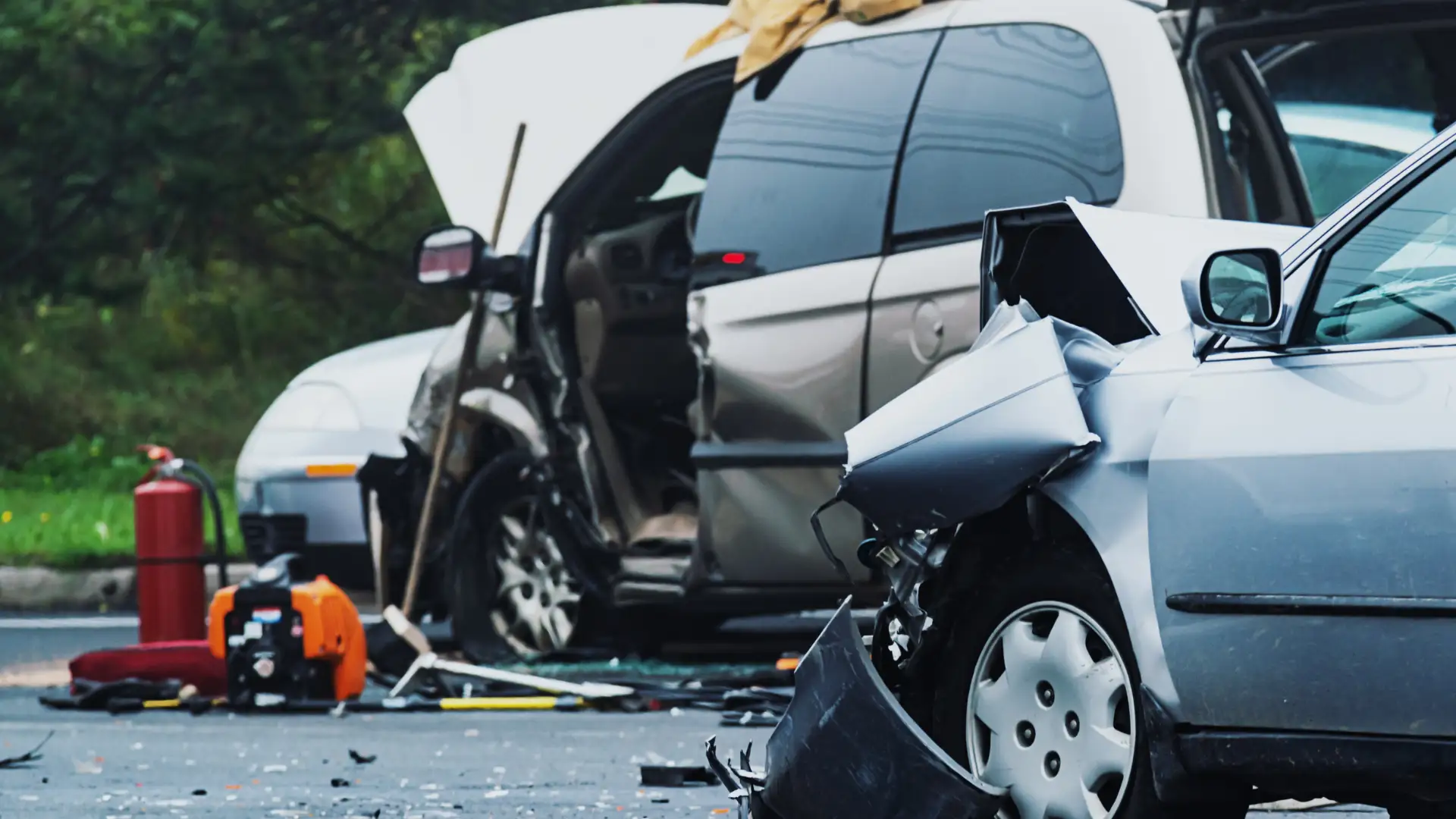 Severely damaged car after a collision with the door and window shattered.