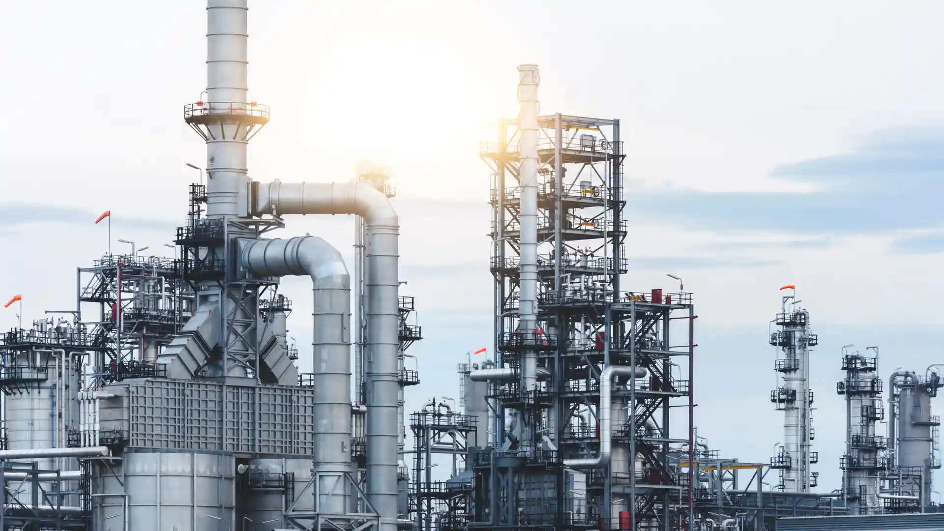 Industrial refinery towers and pipes in daylight