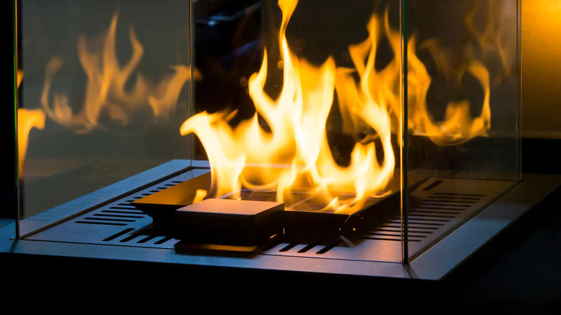 Open flames rising from a tabletop fire burner or indoor fire feature.