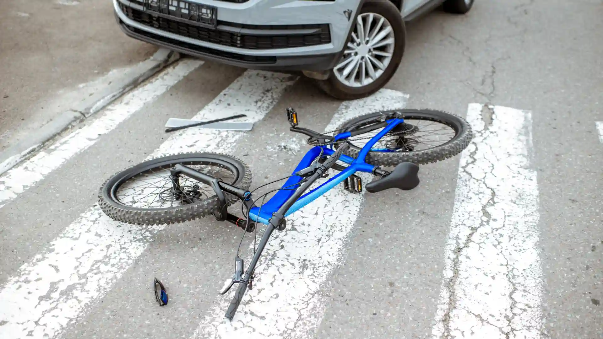 Damaged bicycle lying on the road after a collision with a car.
